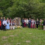 Przedstawiciele władz oraz uczniowie składają kwiaty przy pomniku na Papieżówce podczas uroczystości upamiętniającej.